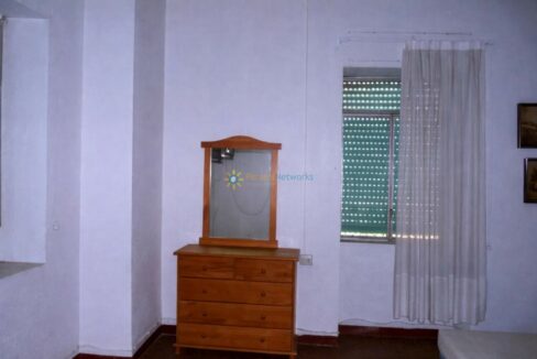 Cómoda de madera junto al espejo