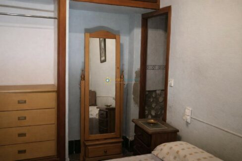 Habitación con espejo y muebles sencillos