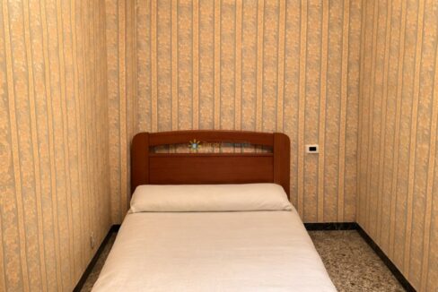 Habitación pequeña con cabecero de madera