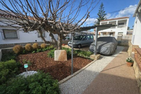 Jardín residencial y área de estacionamiento