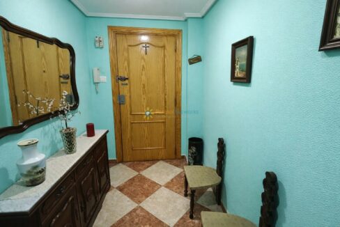 Pasillo con puerta de madera decorada