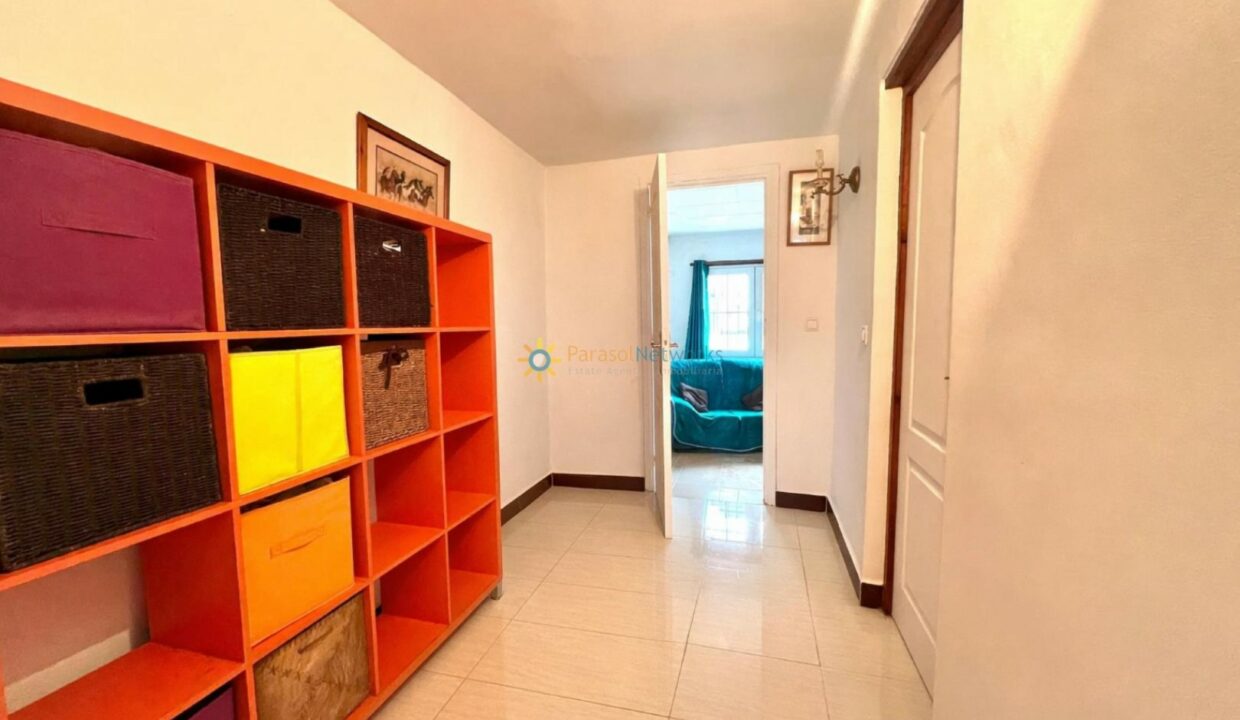 Pasillo luminoso con unidad de almacenamiento naranja