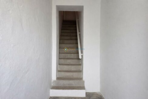 Pasillo minimalista con escalera de concreto