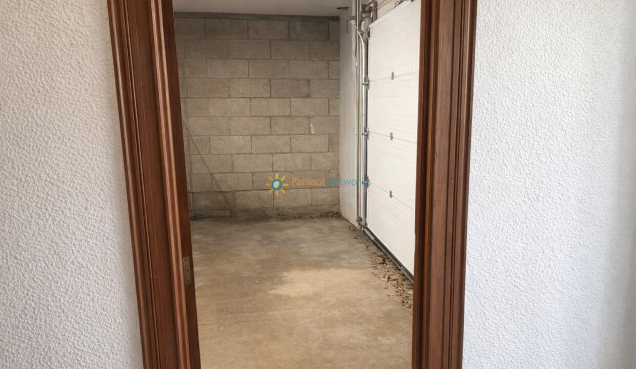 Puerta abierta hacia el garage iluminado